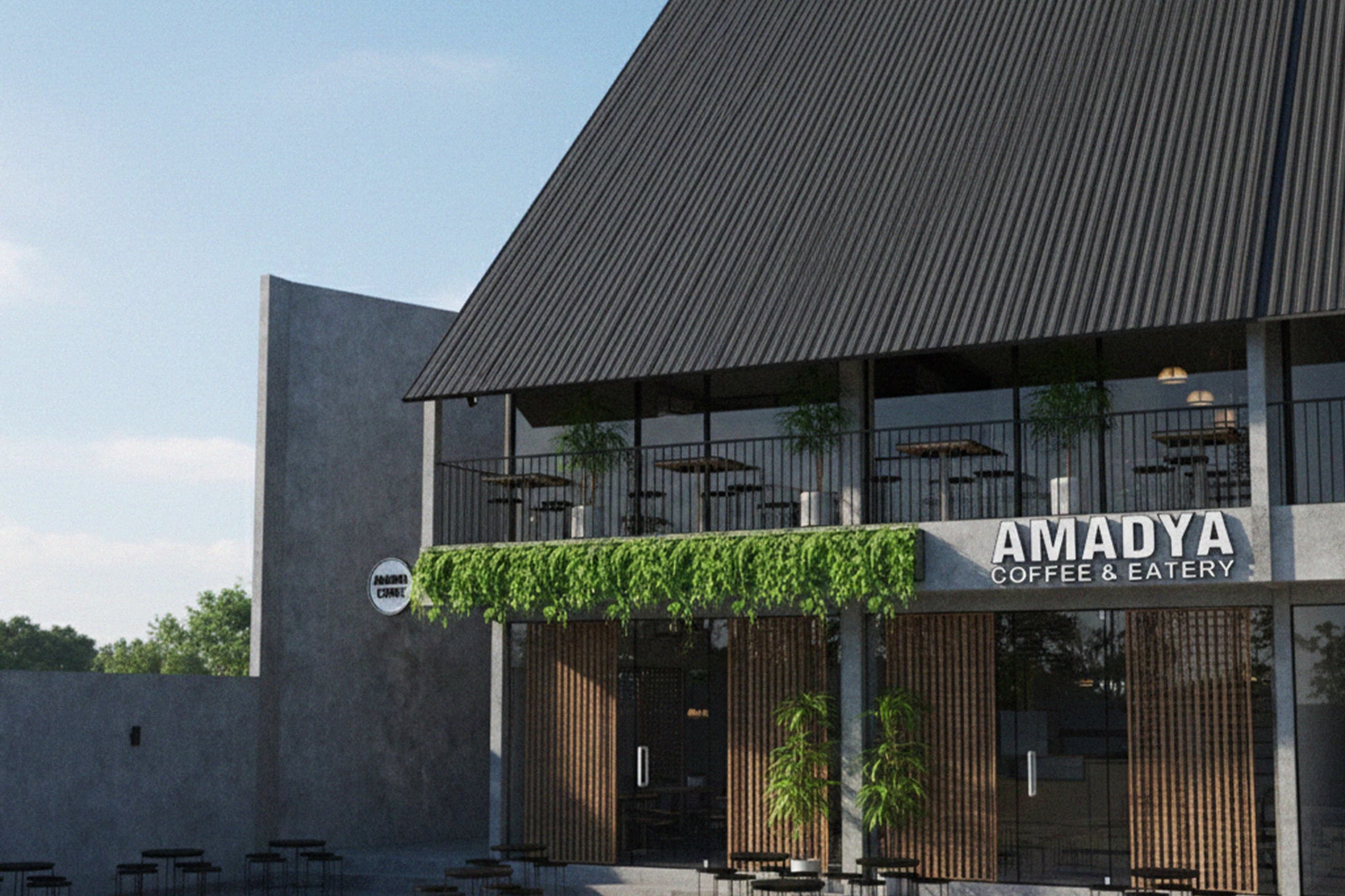 Amadya storefront with a dark corrugated roof, hanging greenery along the fascia and an open terrace below.